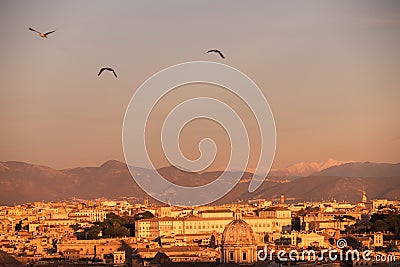 View of the city at sunset. On the horizon tops of mountains in the snow. Rome. Stock Photo