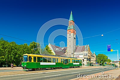 View of a city tram in Helsinki and the old historical building of The National Museum of Finland Stock Photo