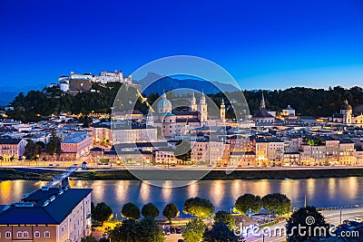 View of cityscape of Salzburg Cathedral, Fortress Hohensalzburg, and old castle in center of old town with river and road along Stock Photo
