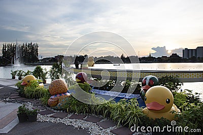 View cityscape Udonthani city and landscape and yellow duck rubber doll in pond dusk time for thai people travel visit relax at of Editorial Stock Photo