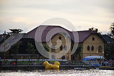View cityscape Udonthani city and landscape and yellow duck rubber doll in pond dusk time for thai people travel visit relax at of Editorial Stock Photo
