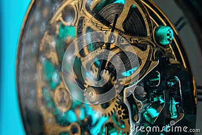 The view is close. Mechanism of a wristwatch. Gears, levers, springs and gems. Engraving and gold. old scratched glass. Concept of Stock Photo