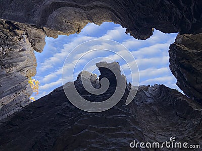 View of the clouds in the sky from the window of the cave Stock Photo