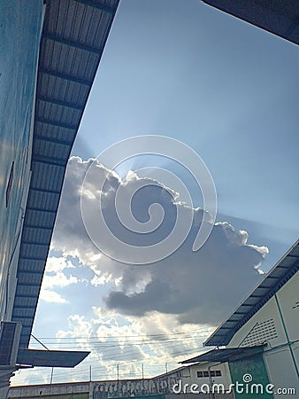 view of cloudy clouds between buildings in Kartasura Stock Photo