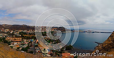 View with coastal buildings, blue water and pier of San Sebastian de la Gomera, Canary Islands Stock Photo