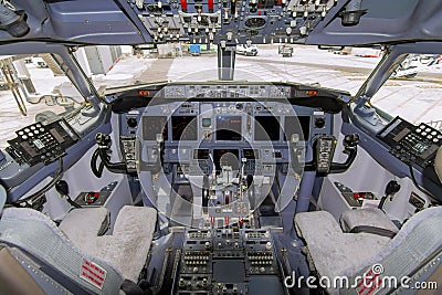 A view of the cockpit of a large commercial airplane a cockpit . Cockpit view of a aircraft cruising Control panel in a plane Editorial Stock Photo