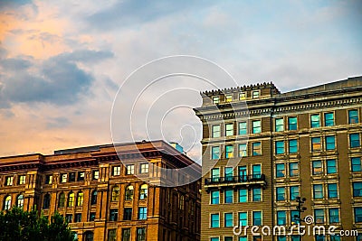 Sunset over old brick city apartment buildings Stock Photo