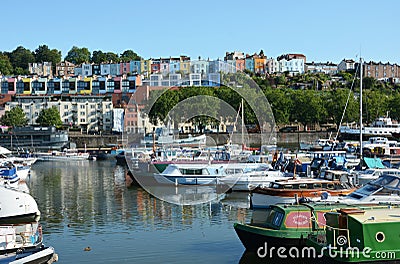 A view of the colourful terraces of houses overlooking the boats moored in Bristol Harbour. Editorial Stock Photo