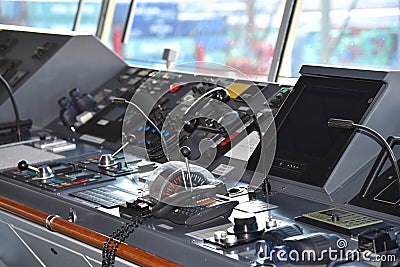 View of the control console on the navigational bridge of the cargo ship. Stock Photo
