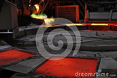 View of the copper casting to the molds in the smelting of the industrial plant. Smelting is a process of applying heat to ore. Stock Photo