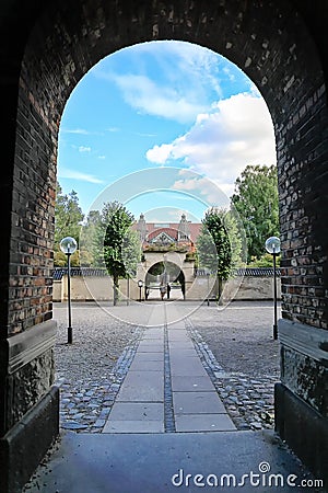 View of the courtyard and a walkway with two gates leading to t Editorial Stock Photo