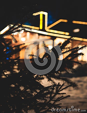 View of a cozy wooden scandinavian cabin cottage chalet house covered in snow near ski resort lodge in winter with the christmas Stock Photo