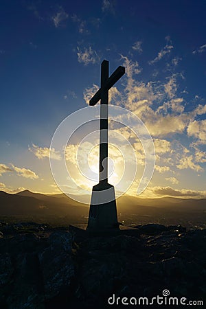 View of the cross during a sunset at Bray Head, Ireland Stock Photo