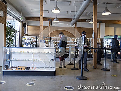 Woodinville, WA USA - circa December 2021: View of customers waiting in line at High Leaf cannabis shop during the coronavirus Editorial Stock Photo