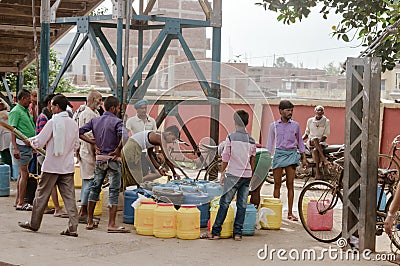 View of Dairy Milk Industry Procurement Distribution on Indian railway station platform in morning. Manual fat testing adulterated Editorial Stock Photo