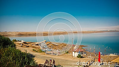 Tourists relaxing and swimming in the water of the Dead Sea in I Stock Photo