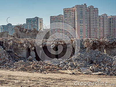 Deconstruction of building in front of new buildings Stock Photo