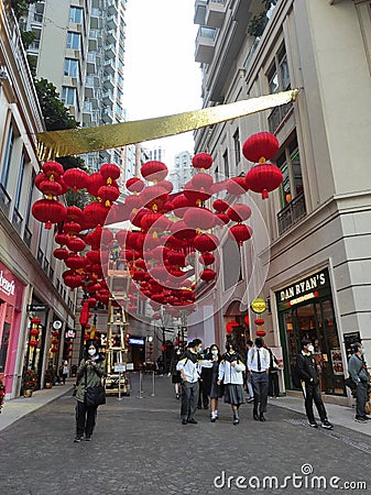 View of decorative lanterns hanging between buildings welcoming Chinese New Year on Lee Tung Avenue, Wan Chai, Hong Kong. Editorial Stock Photo