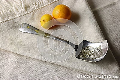 OLD VINTAGE SUGAR SPOON WITH YELLOW FRUIT Stock Photo