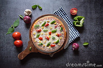 View directly from above of Italian delicacy pizza with capsicum tomatoes and cheese Stock Photo