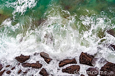 View from directly above on sea wave and rocks Stock Photo