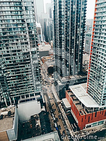 View on downtown Toronto city in Canada, Ontario from top above roof. Aerial urban view from high. Busy urban city street. Urban Stock Photo