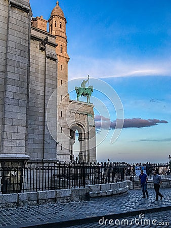 View at dusk of equestrian statue of King Saint Louis on front of Sacre Coeur basilica on Montmartre Editorial Stock Photo