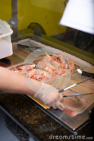 employee restocks Mongolian BBQ restaurant meat Stock Photo
