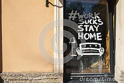 View of an empty storefront with the sign stay at home Editorial Stock Photo