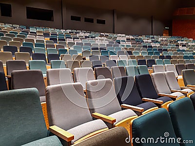 View of empty theater or cinema hall with empty rows of audience seats during the pandemic and lockdown with cancelled events Stock Photo