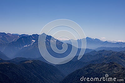 View of endless mountain ranges in the haze of the day Stock Photo