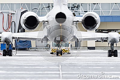 View of the engines and tail of the aircraft when push back at the airport. Stock Photo