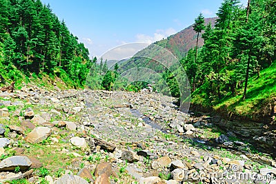 View enroute to Prashar Lake trekk trail through river bed. It is located at a height of 2730 m above sea level surrounded by Stock Photo