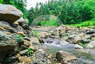 View enroute to Prashar Lake trekk trail through small waterfall rivulet. It is located at a height of 2730 m above sea level Stock Photo