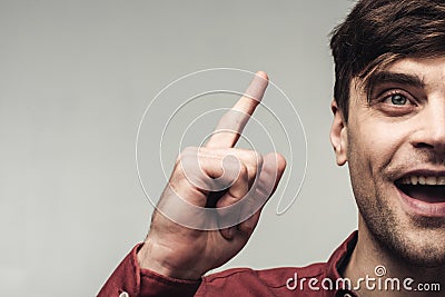 View of excited man showing idea sign isolated on grey, human emotion and expression concept Stock Photo