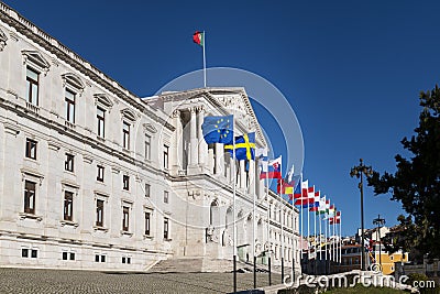 View of the facade of the Assembleia da Republica Portuguese Parliament, with the European union countries flags raised in order Editorial Stock Photo