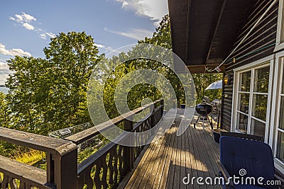 View of facade of typical wooden swedish house with wooden patio. Stock Photo