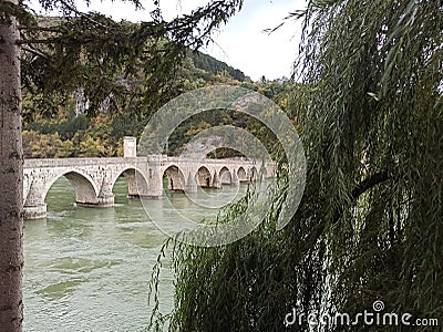 A view of famous bridge over Drina throug the trees, Visegrad, Bosna and Herzegovina Stock Photo