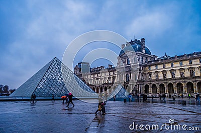 View of famous Louvre Museum and gallery with Louvre Pyramid in Paris France Editorial Stock Photo