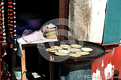 View of female indigenous hand making tortillas on comal, traditional food Stock Photo