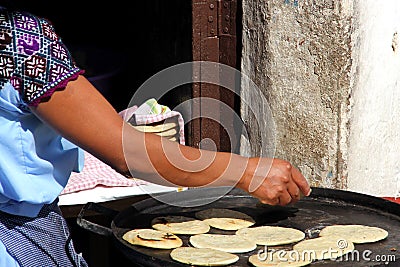 View of female indigenous hand making tortillas on comal, traditional food Stock Photo