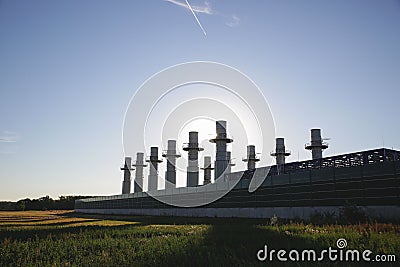 View from a field to the power generators of a large nuclear power plant with blue sky Stock Photo