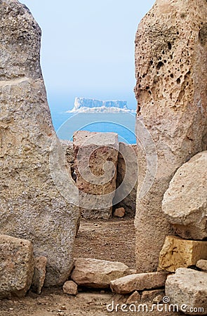 The view of Filfla through the foramen of two Orthostats of Hagar Qim, Malta Stock Photo