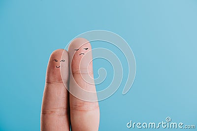 View of fingers as dissatisfied couple isolated on blue Stock Photo