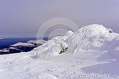 View from the iced mountain top to the winter valley Stock Photo