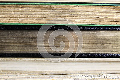 View on fore edge of isolated stacked old yellowed books with copy space for text Stock Photo