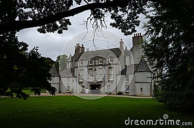 View of Leith Hall Castle among the trees on a cloudy day, Scotland, United Kingdom Stock Photo