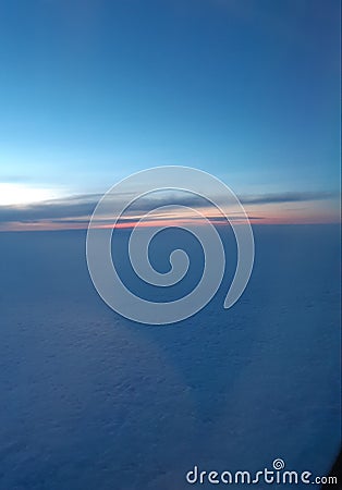 The view frombthe airplane. Sunrise. Clouds and sun. Beautiful view from the plane. Stock Photo