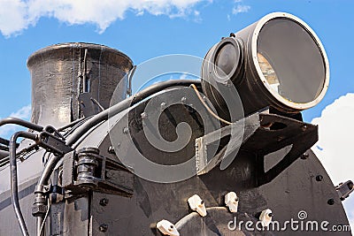 View of the front of the old steam locomotive with the smokestack, headlight and smokebox door Stock Photo