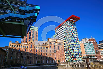 View on futuristic buildings in harbor against dark blue cloudless sky focus on colorful colorium building Editorial Stock Photo